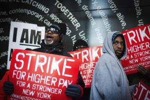 Demonstrators protesting low wages and the lack of union representation in the fast food industry chant and hold signs in New York